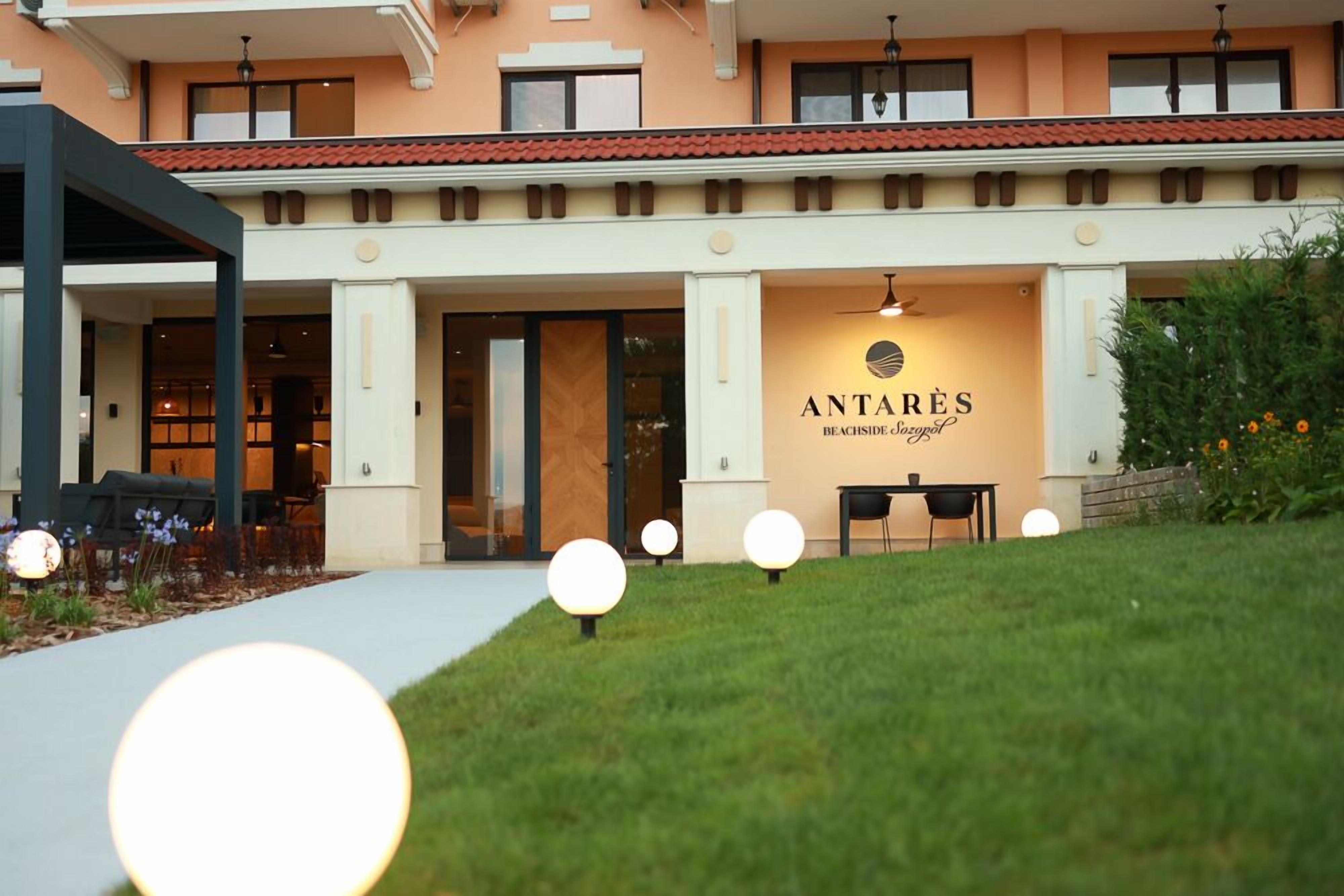 A hotel entrance with a sign reading "ANTARES BEACHSIDE".