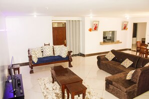 Family Apartment | Living area | 24-inch Smart TV with digital channels - Lux Suites Marrakech Apartments (Mombasa)