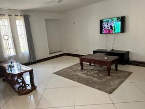 Family Apartment | Living area | 24-inch Smart TV with digital channels - Lux Suites Marrakech Apartments (Mombasa)