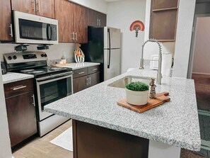 Fridge, coffee/tea maker, cookware/dishes/utensils