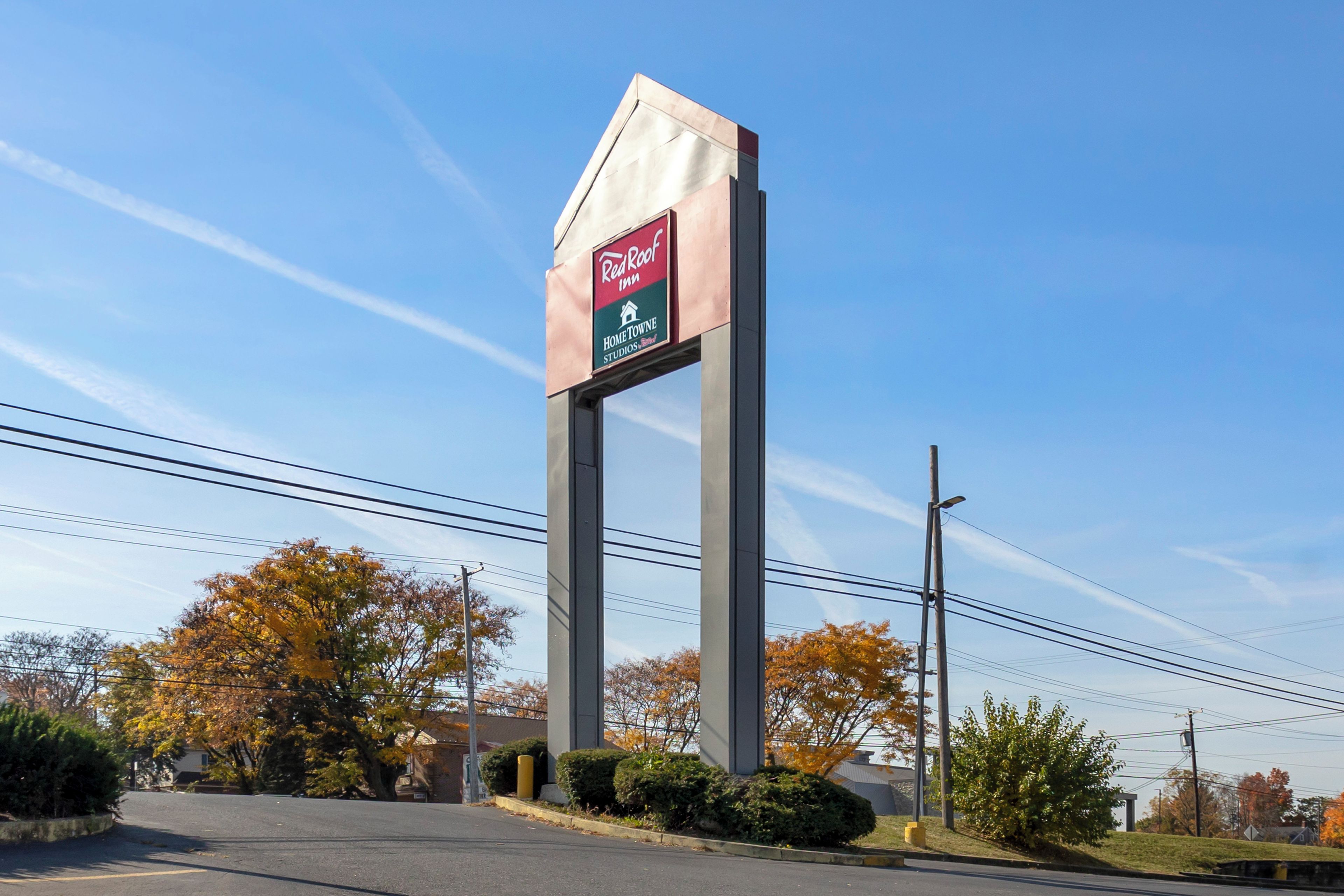 A Red Roof Inn sign with a house symbol, indicating a home stay option.