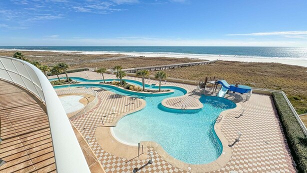 A resort pool area with multiple swimming pools, a water slide, and a beach view. - 3rd Floor!! Parking Level!  Avoid the Elevators!! Lazy River!! (Orange Beach)