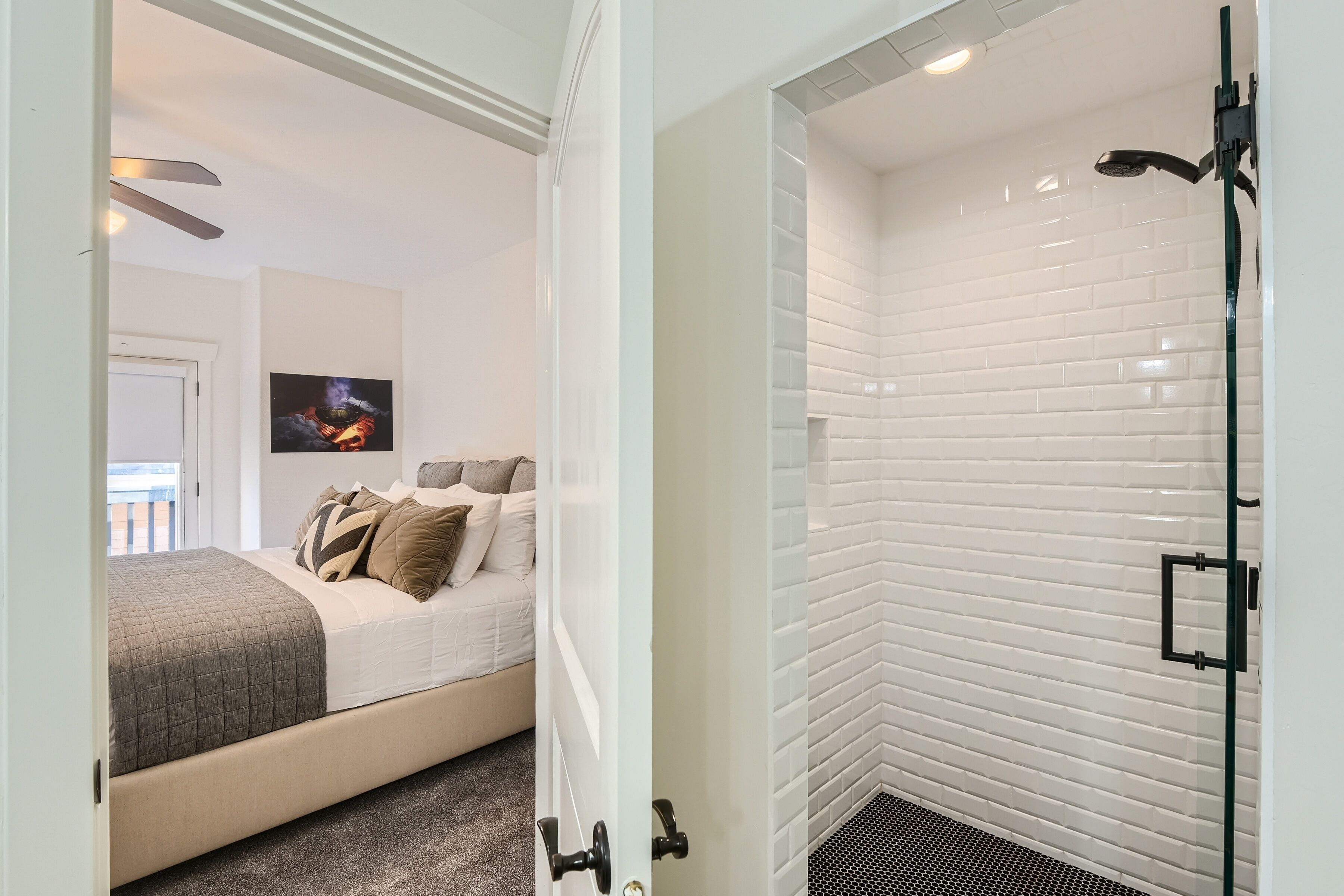 A modern bedroom with a bed, a nightstand, and a wall-mounted TV.
