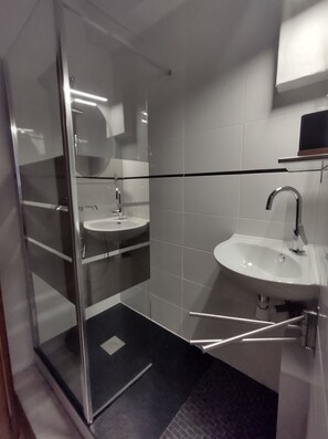 Shower, hair dryer, towels, toilet paper