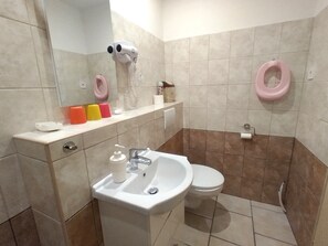 Ein Badezimmer mit Waschbecken, Toilette und Spiegel.