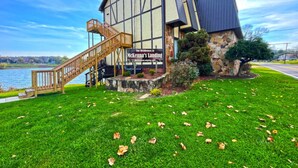 A building with a stone facade, a wooden staircase, and a sign reading "McKenna's Landing." - Captain's Quarters | One Bed Condo Waterfront on Ohio River (Marietta)