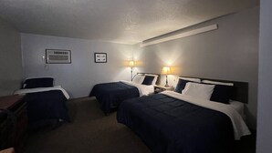 A hotel room with three single beds, each with a bedside table and lamp. - White Lake Lodge - Family Room - Room 6 - Sleeps 5 (White Lake)