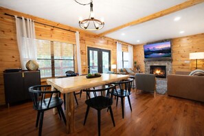 Dining - Escape to CMC Stays cabin in Pigeon Forge, offering over 2,500 square feet of luxurious living space. This cabin is 0.8 miles from the Pigeon Forge strip. It is a 4-bedroom, 3-bathroom home with a theater, game room, and hot tub. It sleeps 12. (Pigeon Forge)
