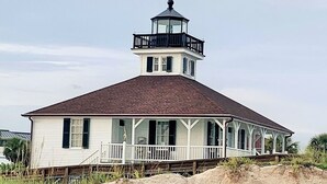 A white building with a balcony and a tower on top, situated on a sandy beach. - Private Guest Suite with Shared Pool Access - just 9 miles from Boca Grande (Port Charlotte)