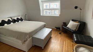 A bedroom with a bed, a nightstand, a lamp, a window, and a chair. - Clean house in great neighbourhood! (Toronto)