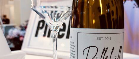 A wine bottle labeled 'Pillehill Solaris 2023' and a wine glass on a table.