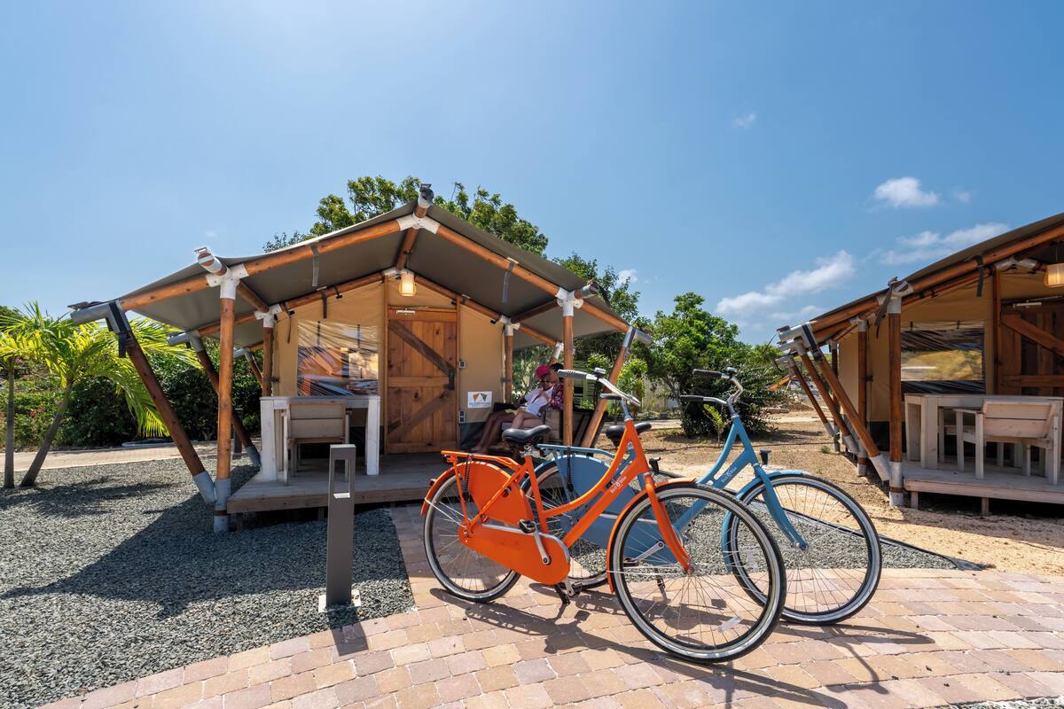 Una estructura de madera con un porche cubierto y una bicicleta estacionada al frente.
