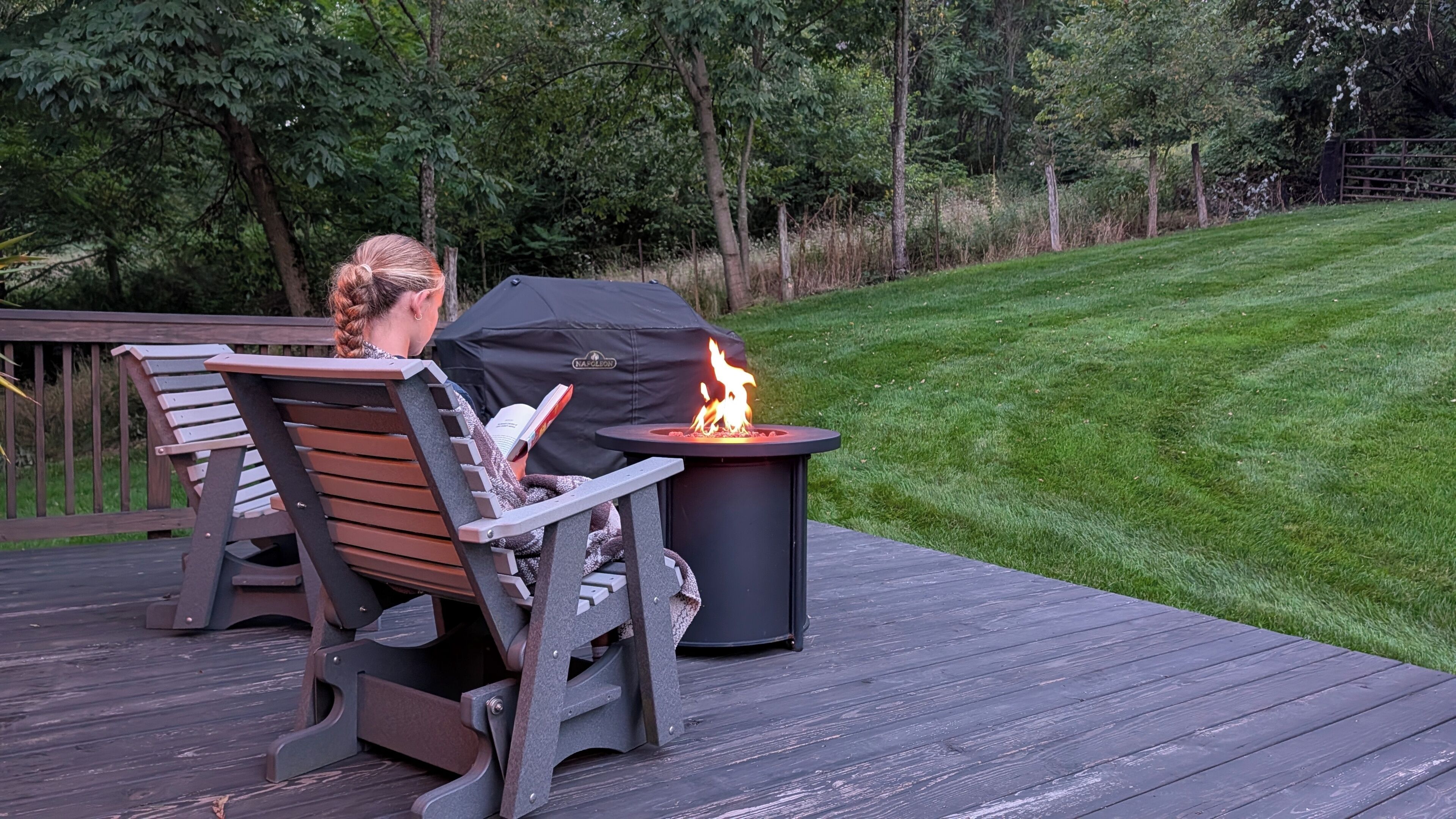 Une terrasse avec un foyer et une chaise.