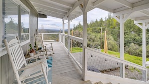 A covered porch with white railings, a bench, and a potted plant. - Bay Area Escape on 5 Acres: Pet Friendly, Views (Greenwood)