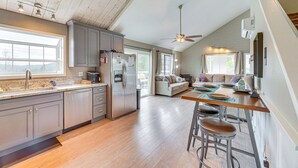 A spacious kitchen with a dining area, wooden floors, and a ceiling fan. - Bay Area Escape on 5 Acres: Pet Friendly, Views (Greenwood)