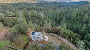 A house surrounded by dense forest with a clear view of the surrounding landscape. - Bay Area Escape on 5 Acres: Pet Friendly, Views (Greenwood)