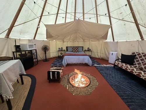 A teepee on 1200-acre ranch where secluded woods envelope the grounds. 