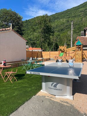 Enjoy table tennis and casual dining in this outdoor recreational area with a play structure for kids.