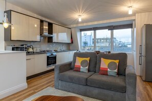 Appartement Deluxe | Coin séjour | TV connectée de 32 pouces avec chaînes numériques