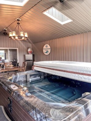 A hot tub with a wooden deck, a ceiling fan, and a sign with the text 'YOLDESAILOR'. - Waterfront with access, 3BR, Dock, Sauna & Hot Tub (Alberton)