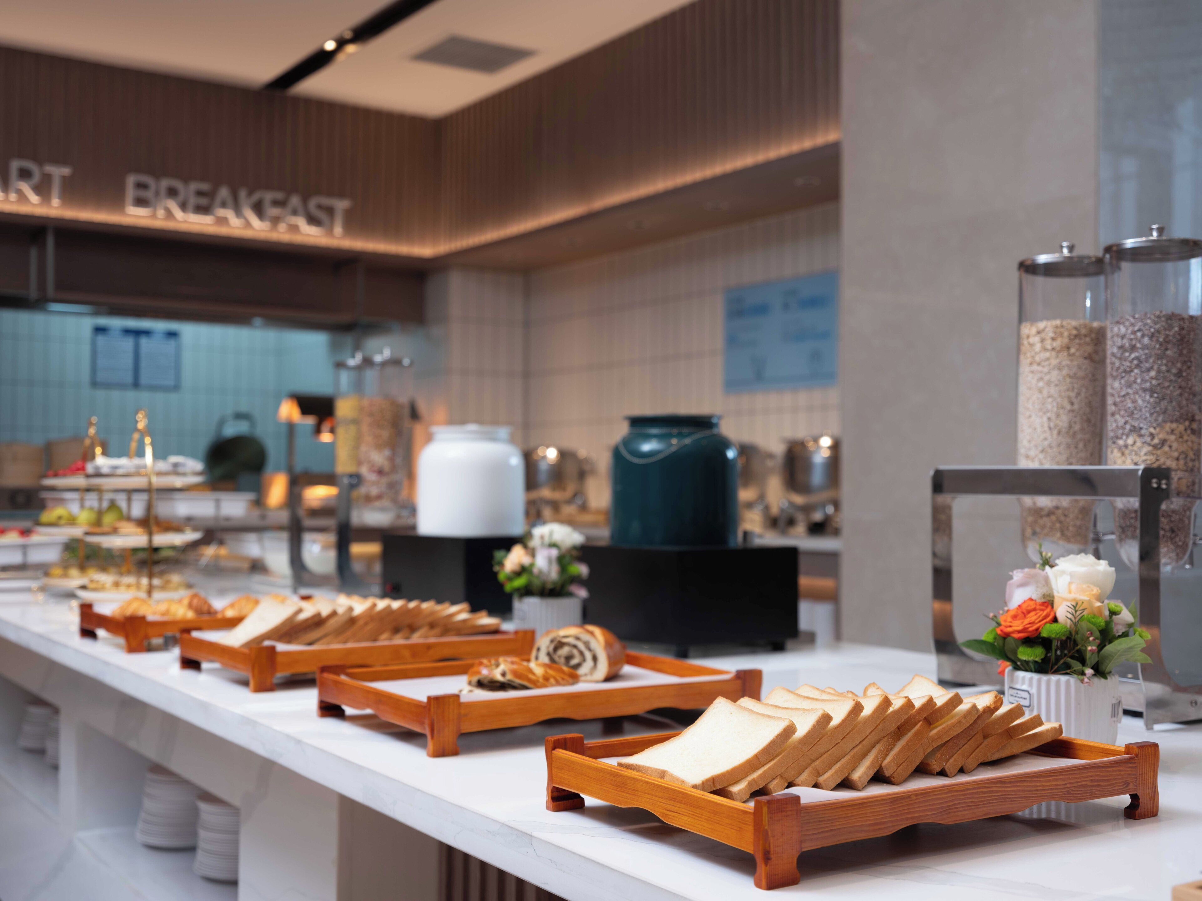 A breakfast buffet with various food items and a coffee station.
