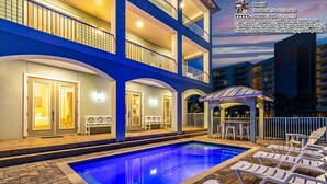 A multi-story hotel with a pool area, outdoor seating, and a view of the beach. - Few steps across from beach, Gulf views, Saltwater pool, Golf cart (Miramar Beach)