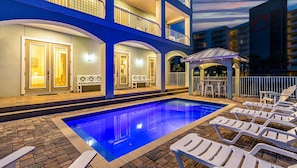 A multi-story hotel with a pool area, outdoor seating, and a view of the beach. - Few steps across from beach, Gulf views, Saltwater pool, Golf cart (Miramar Beach)