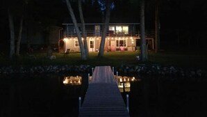 A house with a dock leading to a pond, surrounded by trees. - Lakeside Bliss: Ideal Rental on Potato Lake close to Downtown Park Rapids  (Park Rapids)