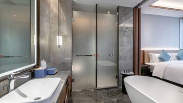 Deluxe King Room | Bathroom | Rainfall showerhead, hair dryer, bathrobes, slippers