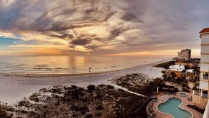 A beach view with a pool and a building with balconies. - Luxury Direct Beachfront 3-bedroom Pet-Friendly Gated Condo in Redington Shores (Redington Shores)