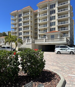 A multi-story building with balconies, a parking area, and a sign indicating 'Owners Only'. - Luxury Direct Beachfront 3-bedroom Pet-Friendly Gated Condo in Redington Shores (Redington Shores)