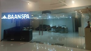 A modern spa with a glass entrance, a reception desk, and a clock on the wall. - condominium rentals at Mactan Newtown (Lapu-Lapu)