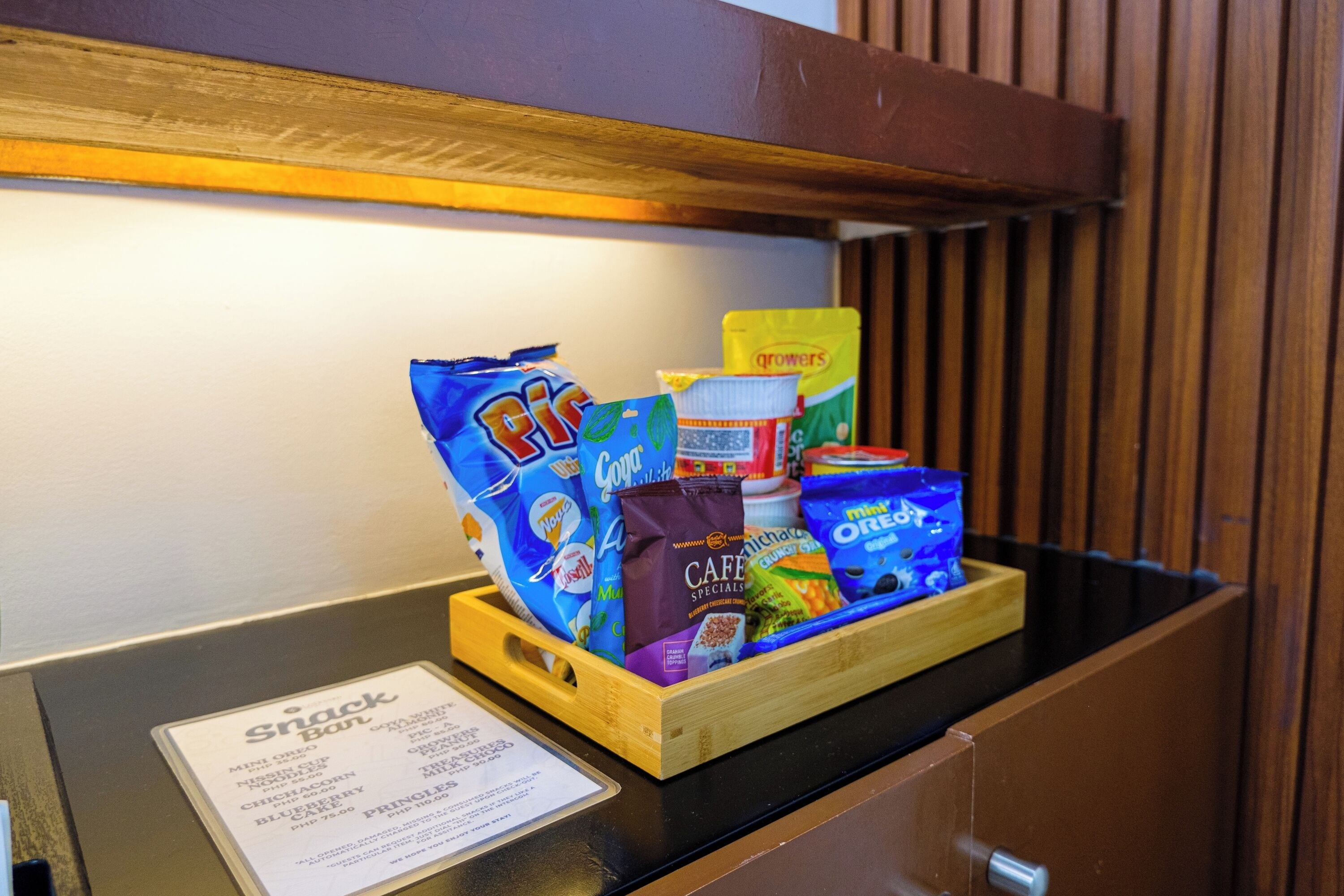 Ein Imbissstand mit verschiedenen verpackten Snacks und einer Speisekarte.