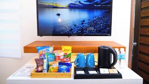 A breakfast buffet with snacks, beverages, and a coffee maker. - Le Dream Hotel near Vigan (Vigan)