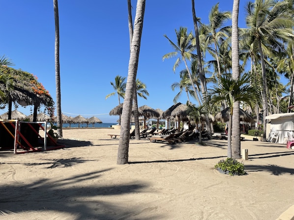 On the beach, sun loungers, beach towels