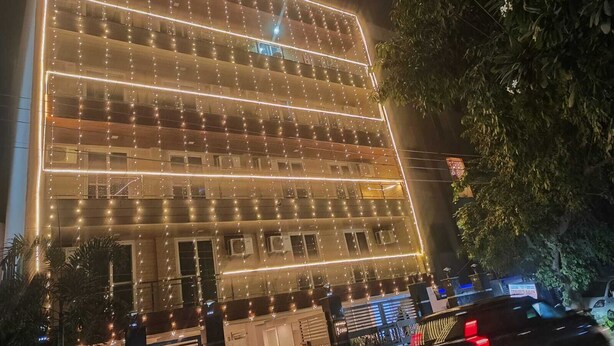 A multi-story building with a modern design, featuring a series of balconies and large windows. - Shaan Stay (Gurugram)