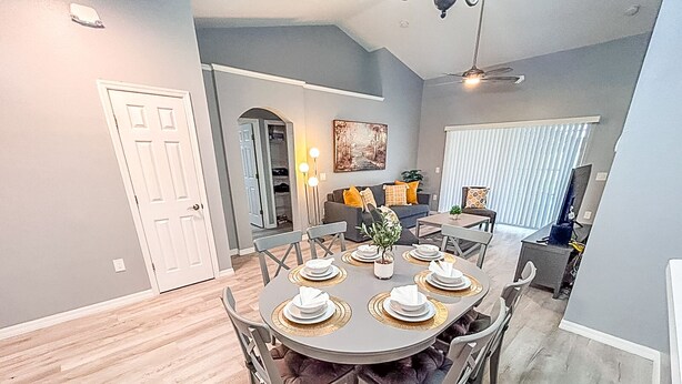 A dining area with a round table set for four, surrounded by chairs. - Modern Home w/Pool close to Disney Florida theme parks (Kissimmee)