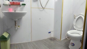 A bathroom with a sink, toilet, and shower. - Thien Phuoc Hotel - by Bay Luxury (Ho Chi Minh City)