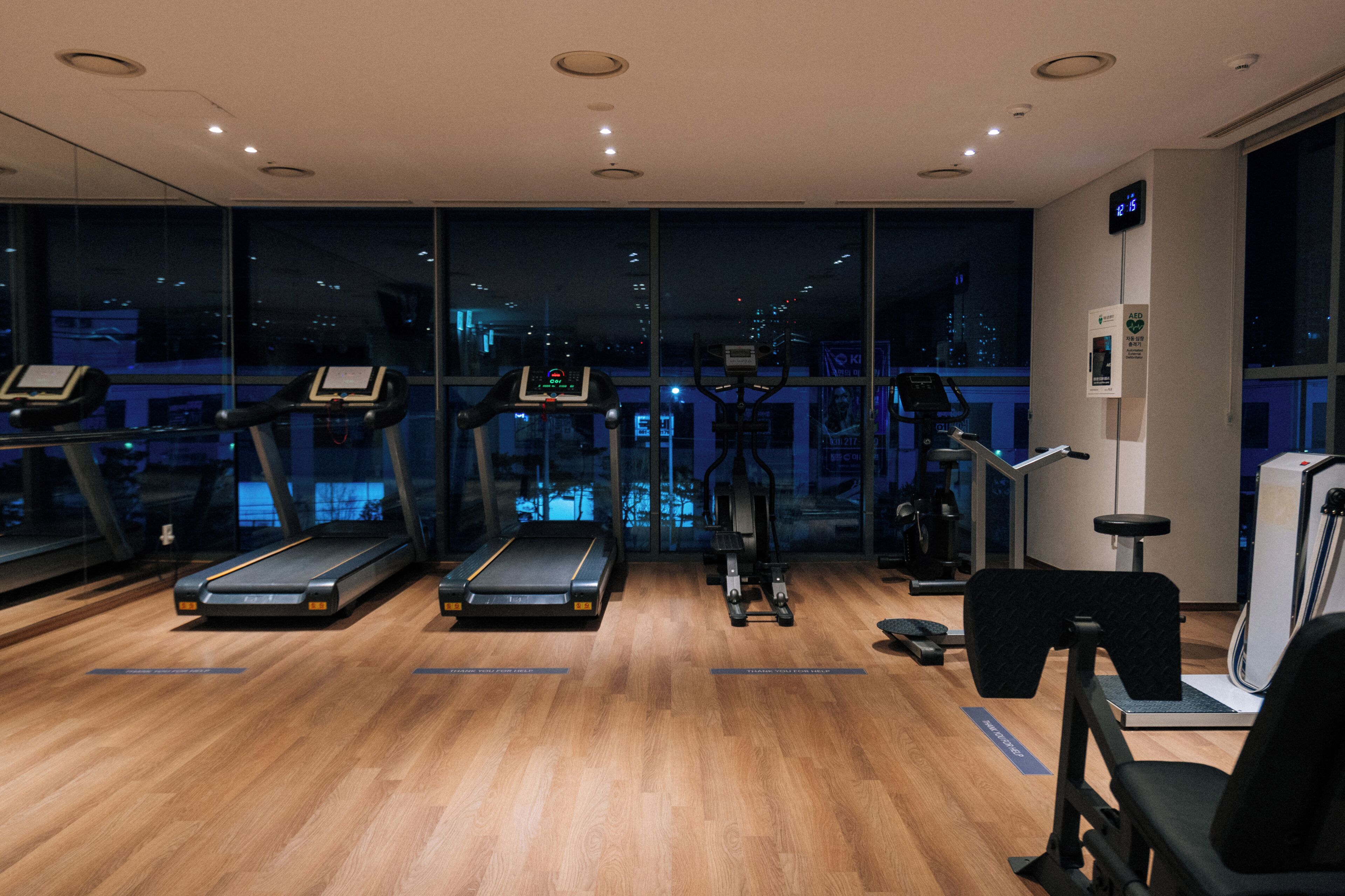 A gym with treadmills, exercise bikes, and a weight machine.