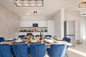 A modern kitchen with white cabinets, a built-in oven, and a stainless steel refrigerator. - Family Resort Santa Maria II Penthouse (Novalja)