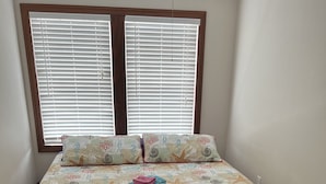 A bedroom with a bed, two windows with blinds, and a carpeted floor. - Luxury Beach Side Home Ii 2 Bedroom Home by RedAwning (Norfolk)