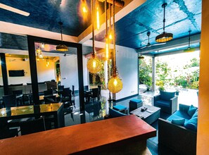A modern restaurant with a bar area, dining tables, and hanging lights. - The Yacht Near CMB-Bandaranaike Intl. (Seeduwa - Katunayake)