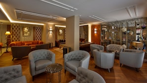A spacious lobby with a variety of seating options, including sofas and armchairs, and a fireplace. -  Anemon Bursa Hotel (Bursa)
