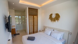 A modern bedroom with a large bed, a television, and a view of the outdoors. - Liminal Palace Villa 2 by Betterplace (Canggu)