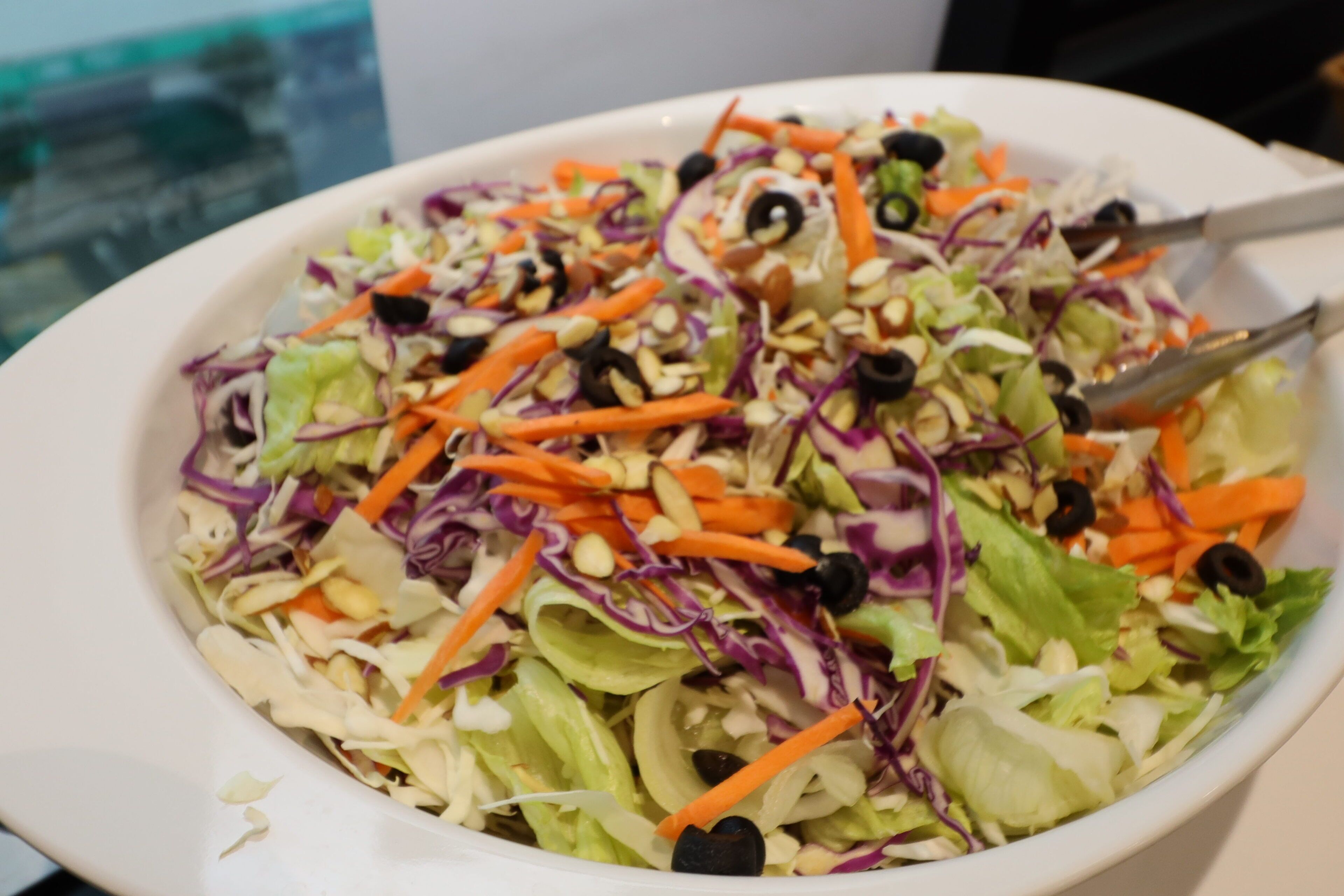 A white bowl filled with a colorful salad.