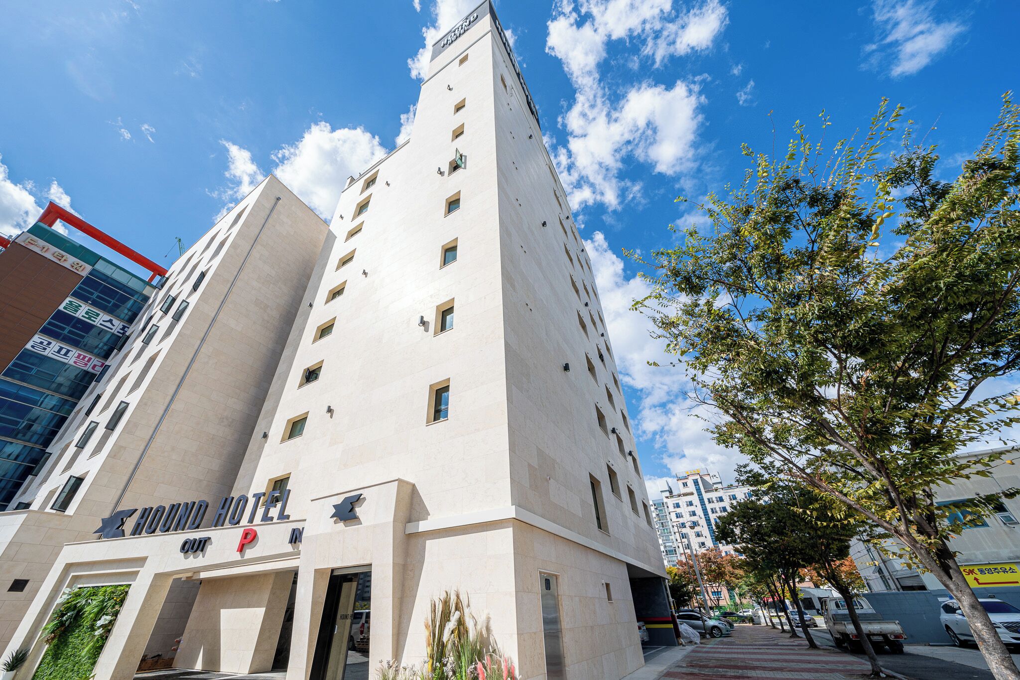 A tall hotel building with a sign indicating it is a hotel.