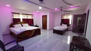 A hotel room with two beds, a desk, and a chair.