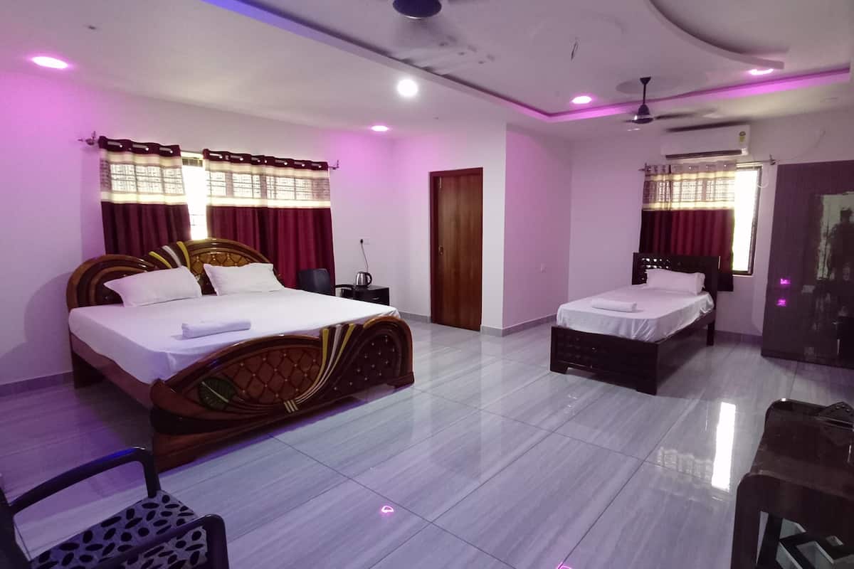 A hotel room with two beds, a desk, and a chair.