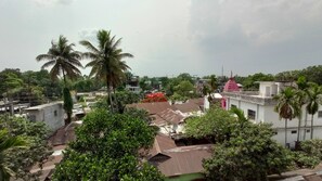 A residential area with houses, palm trees, and a building with a pink dome.