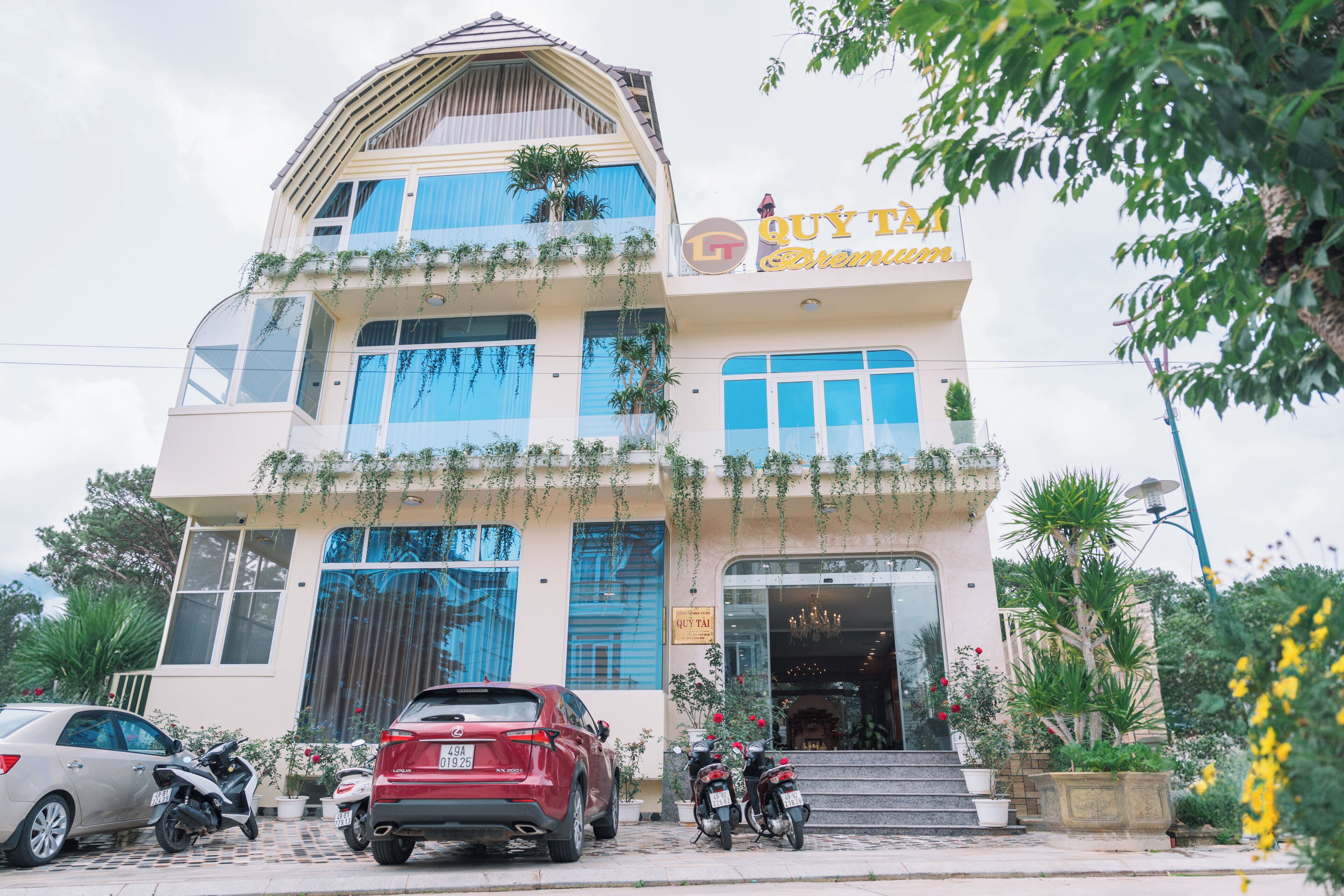 A multi-story building with a sign reading "QUY TAI".